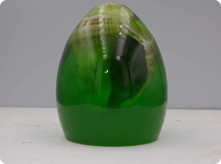 Green glass sculpture with organic design