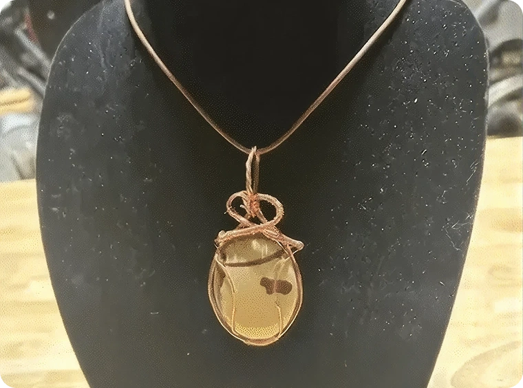 Artistic gemstone pendant on stand