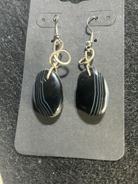 Black stone earrings with silver hooks.